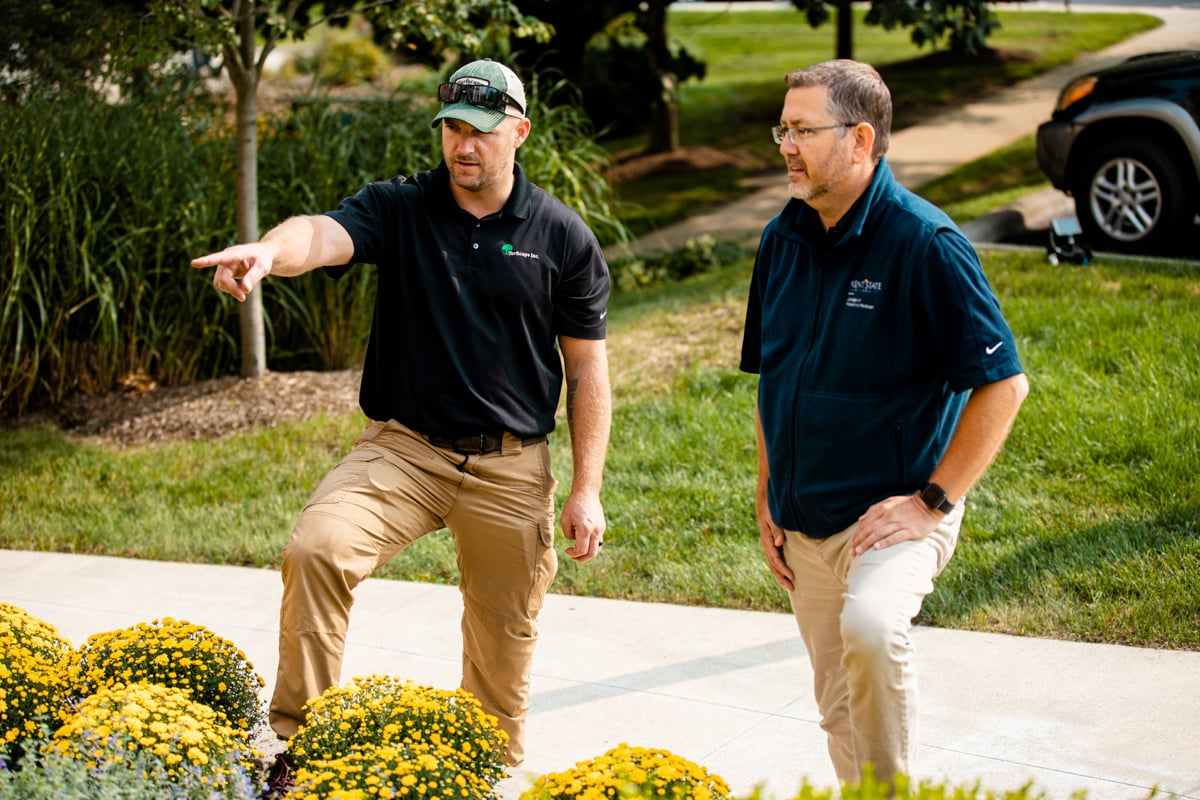 Landscaper walking a homeowner through the plan for their front garden